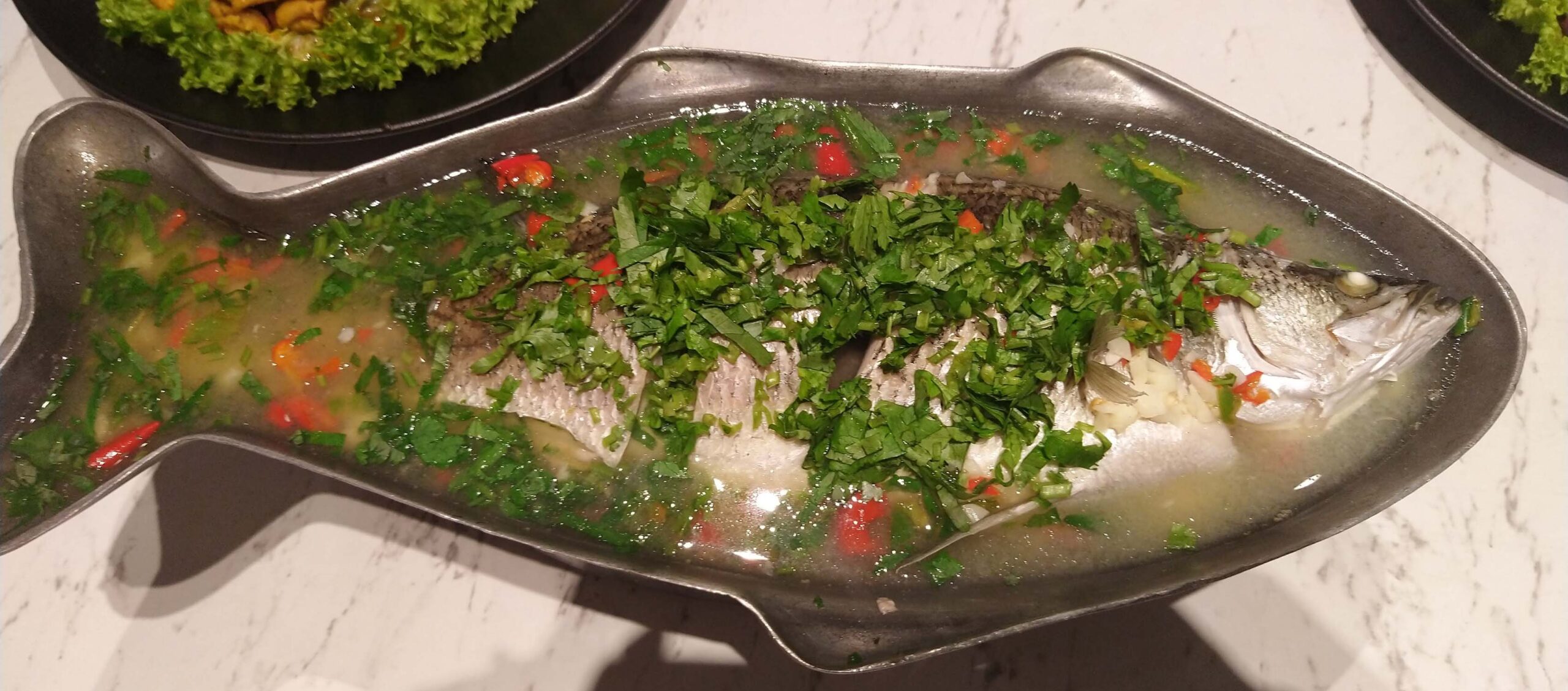 Steamed fish in lime and basil, chili garlic gravy